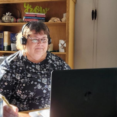 woman using headphones and laptop